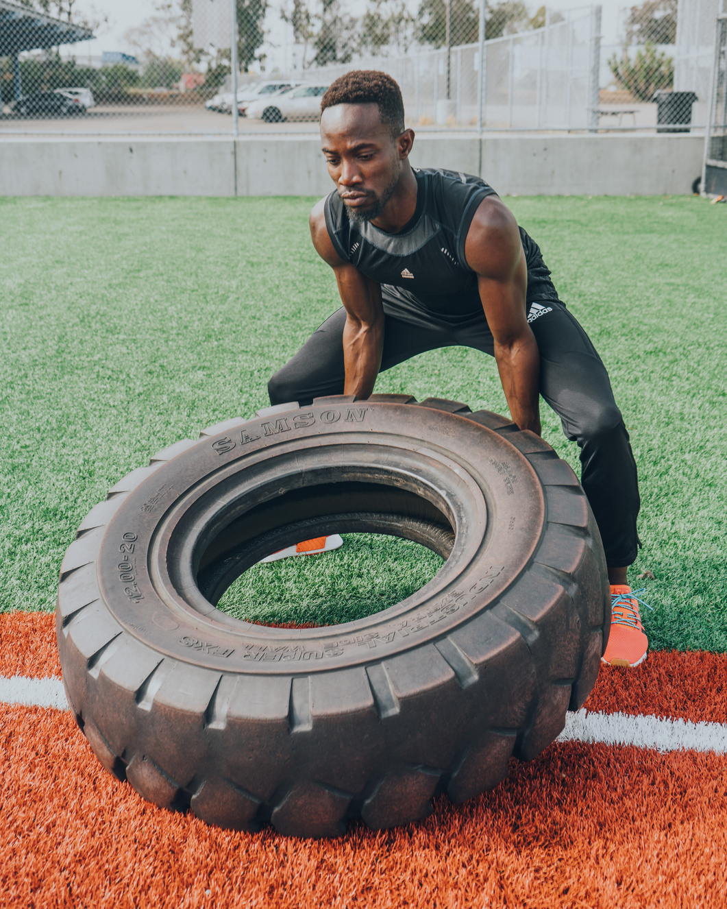 Yinka lifting a tyre during outdoor training